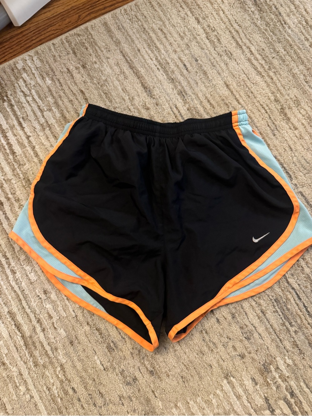 Nike Women's Black Athletic Shorts with Orange Trim and Light Blue Panels